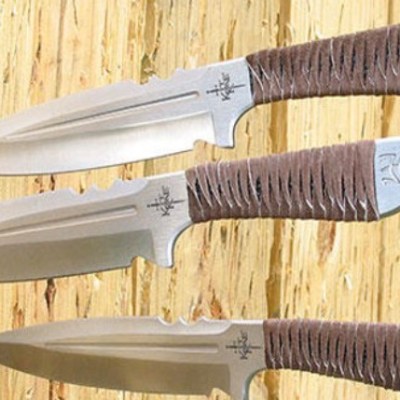 a knife sitting on top of a wooden cutting board