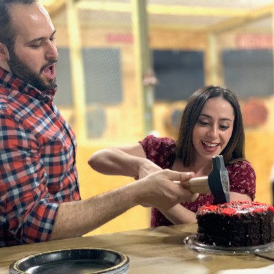 a man and a woman standing in front of a cake