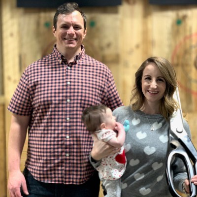 a man and a woman standing in front of a building