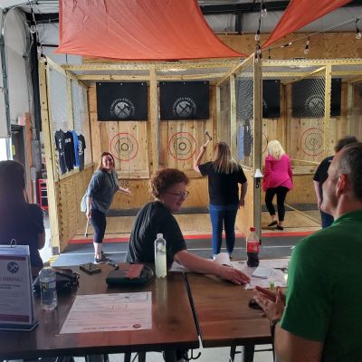 a group of people sitting at a table in front of a building