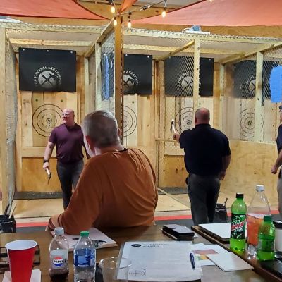 a group of people standing around a table