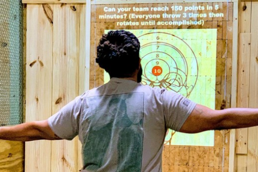 a man standing on top of a wooden door