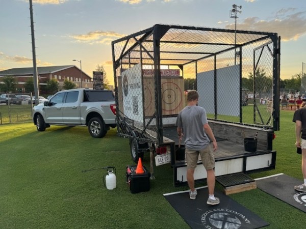 a group of baseball players standing on top of a car